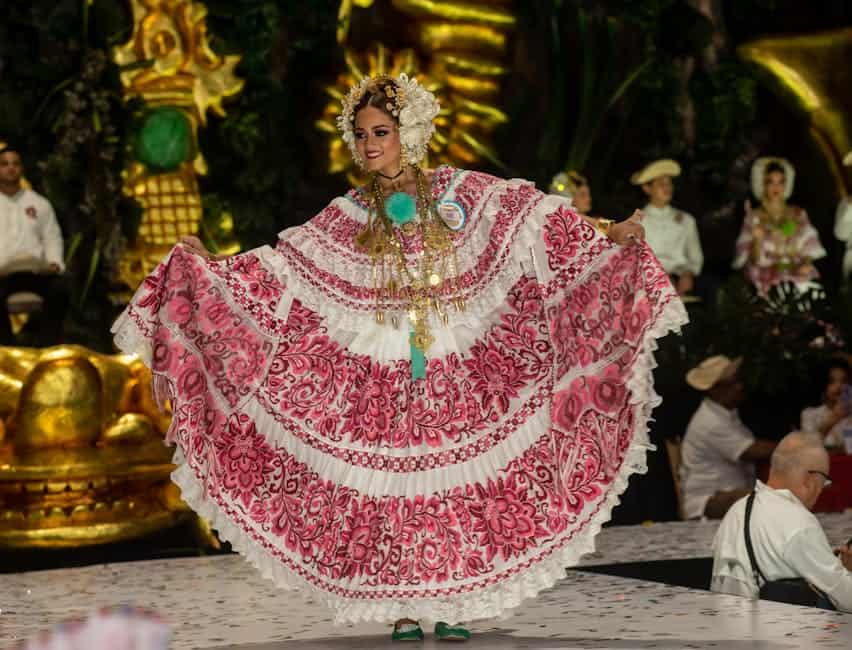 Woman in a vibrant traditional Pollera dress at a cultural festival in Las Tablas, Panama.