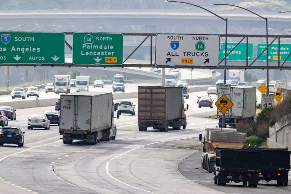 Traffic with trucks and cars on a highway in California heading to Los Angeles.