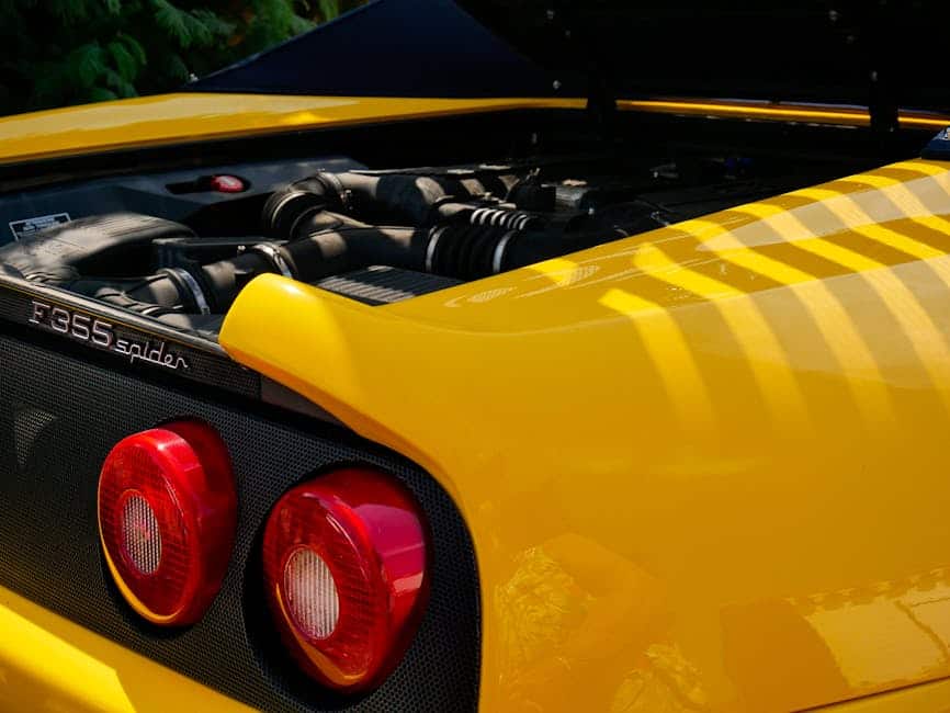 Detailed view of a yellow Ferrari F355 Spider at Noirmoutier-en-l'Île, ideal for automobile enthusiasts.