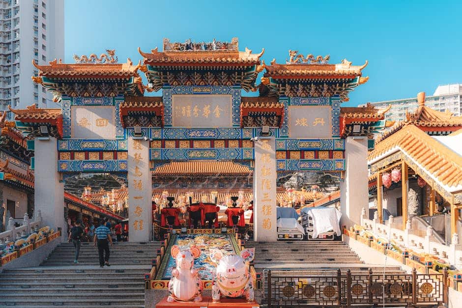 Explore the ornate gateway of Wong Tai Sin Temple in Hong Kong, showcasing intricate traditional architecture.