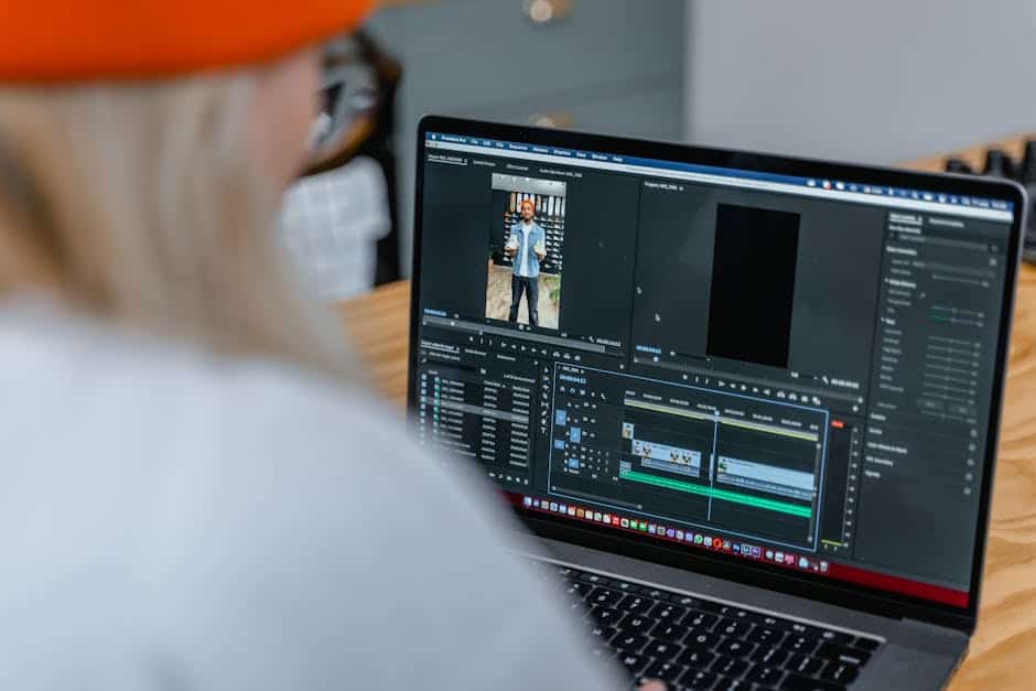 Video editing timeline on laptop showing workflow implementation process.