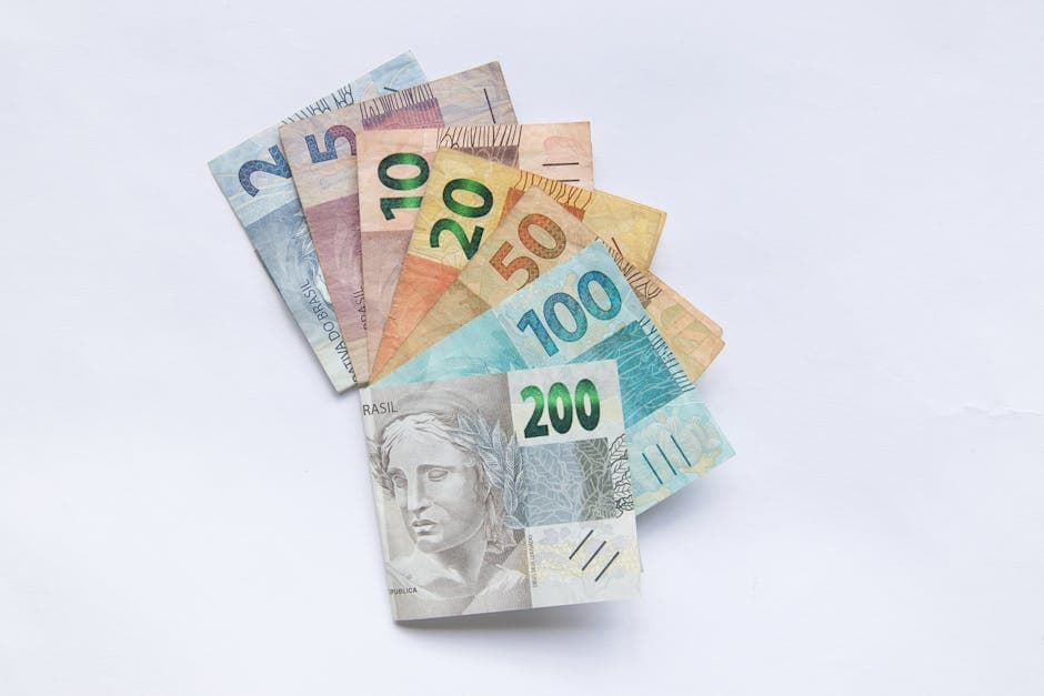 A fan arrangement of colorful Brazilian Real banknotes on a white background showcasing different values.