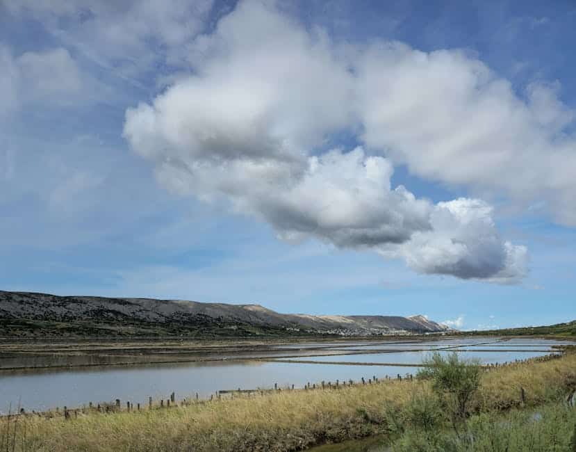 Beautiful panorama of Pag Island with fields and cloudy sky in Croatia.