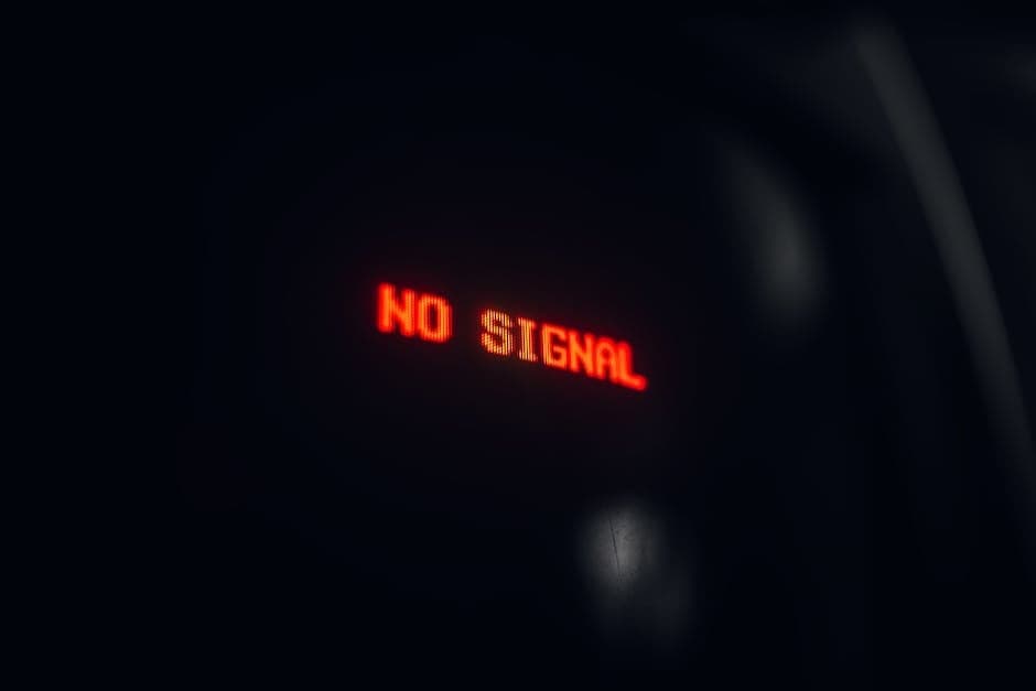 A red LED display indicating 'No Signal' in a dark setting, conveying a tech warning.